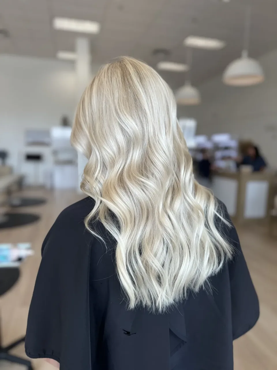 Long blonde waves seen from behind